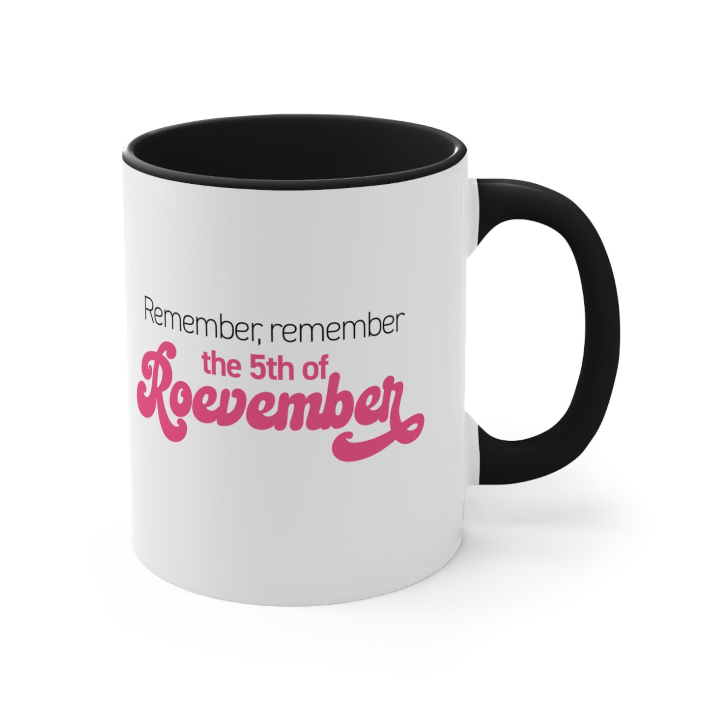 11oz ceramic mug with a black interior and handle featuring the phrase 'Remember, Remember the 5th of Roevember'. The text 'The 5th of Roevember' is highlighted in pink, embellished with a decorative script font and additional swooshes.