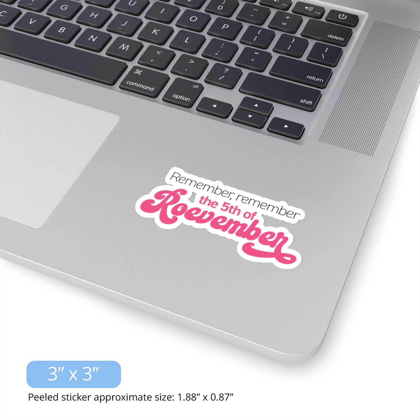 Contextual image of a 3x3 inch (2.88x1.3 inches peeled) indoor sticker featuring the phrase 'Remember, Remember the 5th of Roevember'. The text 'The 5th of Roevember' is highlighted in pink, embellished with a decorative script font and additional swooshes. Ther sticker is on a laptop.