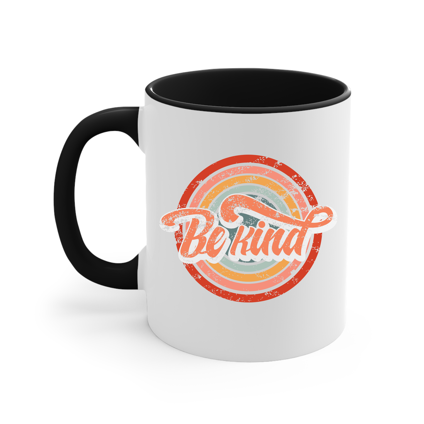 11oz white ceramic mug with a black handle and interior that says “Be Kind.” There is a retro-colored circular rainbow behind it. The text is outlined in white and has a long swoosh that swirls from the end of the letter “d” across the entire word “kind.”