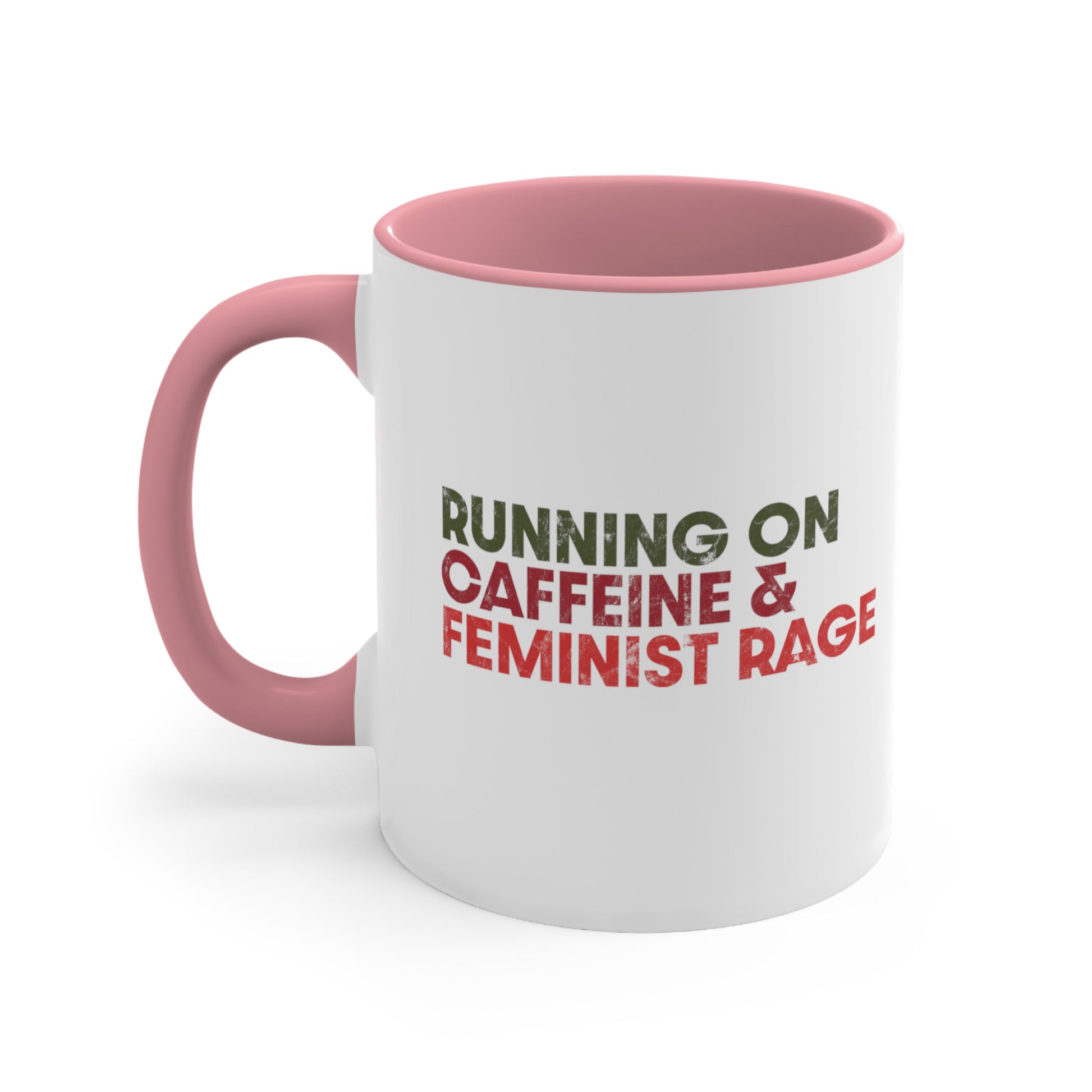 11oz ceramic mug with a pink interior and handle color that says, “RUNNING ON CAFFEINE & FEMINIST RAGE” with each line being a different color. “RUNNING ON” is dark green, “CAFFEINE &” is dark red, and “FEMINIST RAGE” is dark orange. The text is slightly distressed.