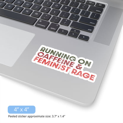 Contextual photo of an indoor 4 x 4 inch (approximately 3.7 x 1.4 inches when peeled) sticker that says, “RUNNING ON CAFFEINE & FEMINIST RAGE” with each line being a different color. “RUNNING ON” is dark green, “CAFFEINE &” is dark red, and “FEMINIST RAGE” is dark orange. The text is slightly distressed. The sticker is on a laptop. 