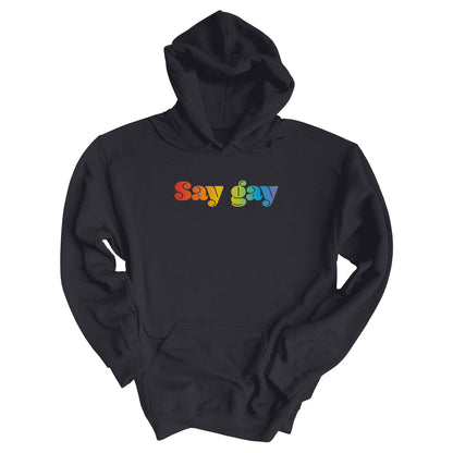 Charcoal color unisex hoodie that reads “Say gay” in a thick, rainbow font.