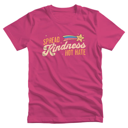 Berry color unisex t-shirt with a graphic that says “Spread Kindness Not Hate” with an illustration of a rainbow shooting star over the word “kindness.” That word is in a script font, and the rest is a regular font in all caps. ”Spread” is on top of the word “Kindness” and aligned left, while “Not Hate” is below the word “kindness” and aligned to the right.