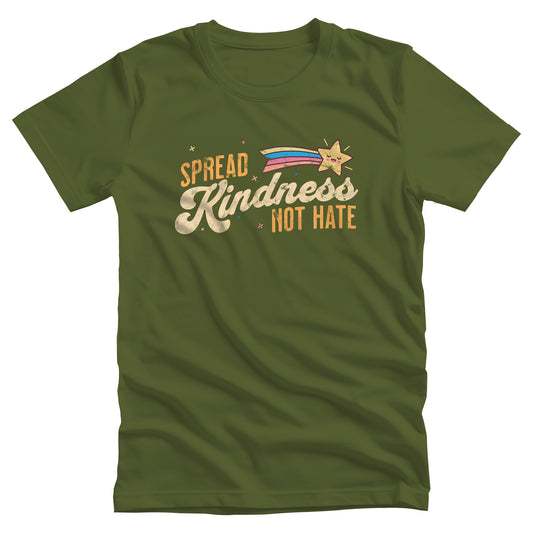 Olive color unisex t-shirt with a graphic that says “Spread Kindness Not Hate” with an illustration of a rainbow shooting star over the word “kindness.” That word is in a script font, and the rest is a regular font in all caps. ”Spread” is on top of the word “Kindness” and aligned left, while “Not Hate” is below the word “kindness” and aligned to the right.