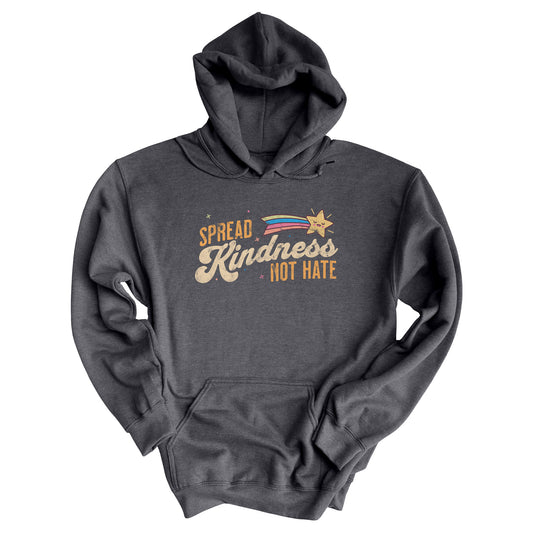 Dark Heather color unisex hoodie with a graphic that says “Spread Kindness Not Hate” with an illustration of a rainbow shooting star over the word “kindness.” That word is in a script font, and the rest is a regular font in all caps. ”Spread” is on top of the word “Kindness” and aligned left, while “Not Hate” is below the word “kindness” and aligned to the right.