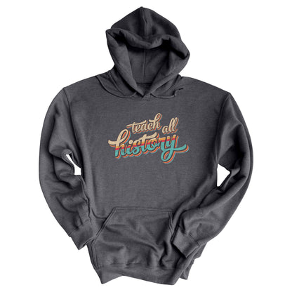 Dak Heather color unisex hoodie that says, “Teach all history" in retro colors and a script font. The text is slightly angled upwards, with the word "history" being larger than "teach all".