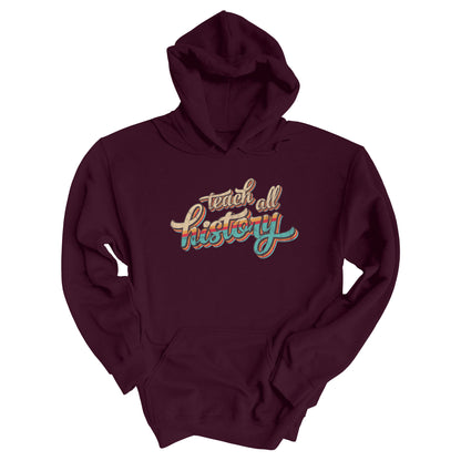 Maroon unisex hoodie that says, “Teach all history" in retro colors and a script font. The text is slightly angled upwards, with the word "history" being larger than "teach all".