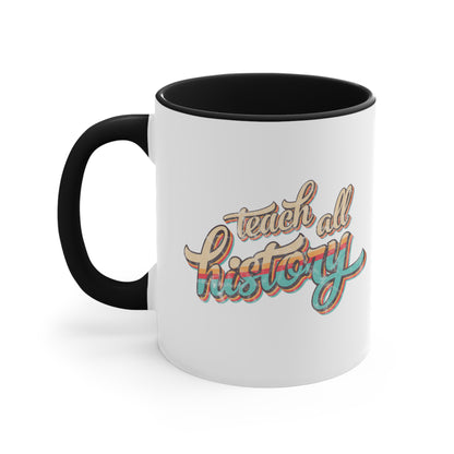 11oz ceramic mug with a black interior and handle that says, “Teach all history" in retro colors and a script font. The text is slightly angled upwards, with the word "history" being larger than "teach all".