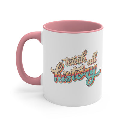 11oz ceramic mug with a pink interior and handle that says, “Teach all history" in retro colors and a script font. The text is slightly angled upwards, with the word "history" being larger than "teach all".