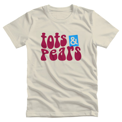 Natural color unisex t-shirt that says, “tots & pears” in a retro font in a mild wave form. The ampersand is cut out from a blue box that is slightly askew.