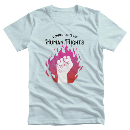 Heather Ice Blue color unisex t-shirt with a graphic of a fist over pink and red flames. The text says, “Women’s rights are human rights” with the words “women’s rights are” arched over the words “Human Rights”.