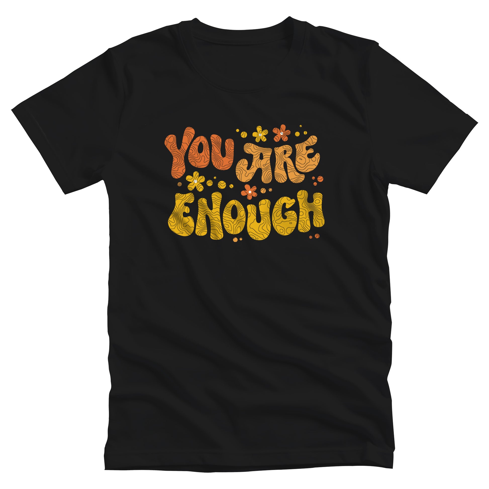 Black unisex t-shirt with a graphic that says “You Are Enough” in a retro font. There are small retro flowers spaced throughout. “You” is reddish-orange, “Are” is orange, and “Enough” is yellow, all retro as well.