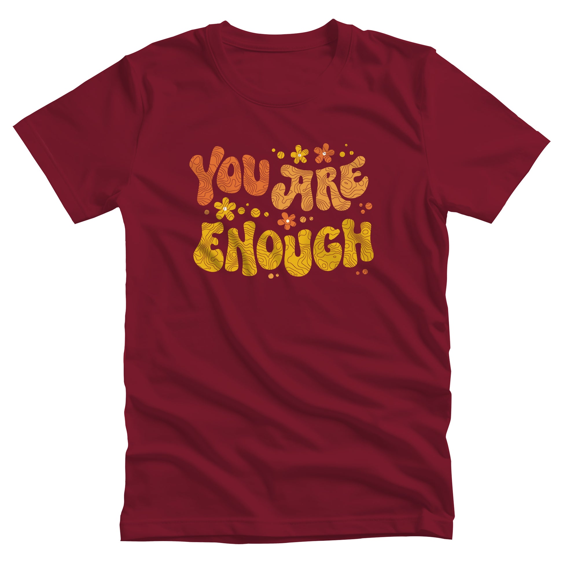 Cardinal color unisex t-shirt with a graphic that says “You Are Enough” in a retro font. There are small retro flowers spaced throughout. “You” is reddish-orange, “Are” is orange, and “Enough” is yellow, all retro as well.