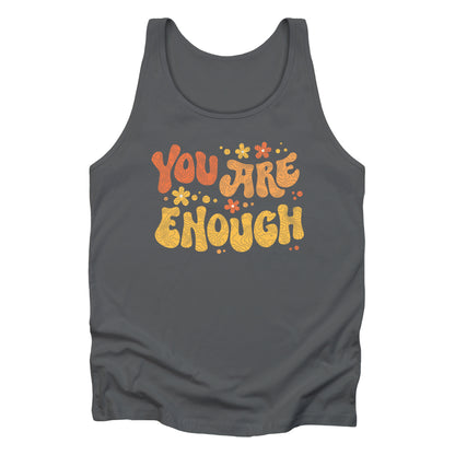 Asphalt color unisex liberal and progressive tank top with a graphic that says “You Are Enough” in a retro font. There are small retro flowers spaced throughout. “You” is reddish-orange, “Are” is orange, and “Enough” is yellow, all retro as well.