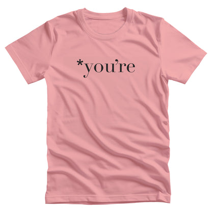 Pink unisex t-shirt that says, “*you’re” with an asterisk before the word.